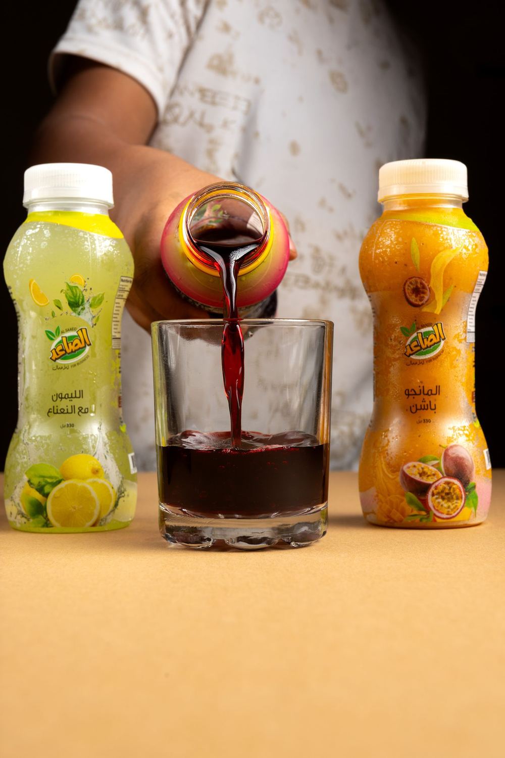 Pouring fresh hibiscus drink into a glass